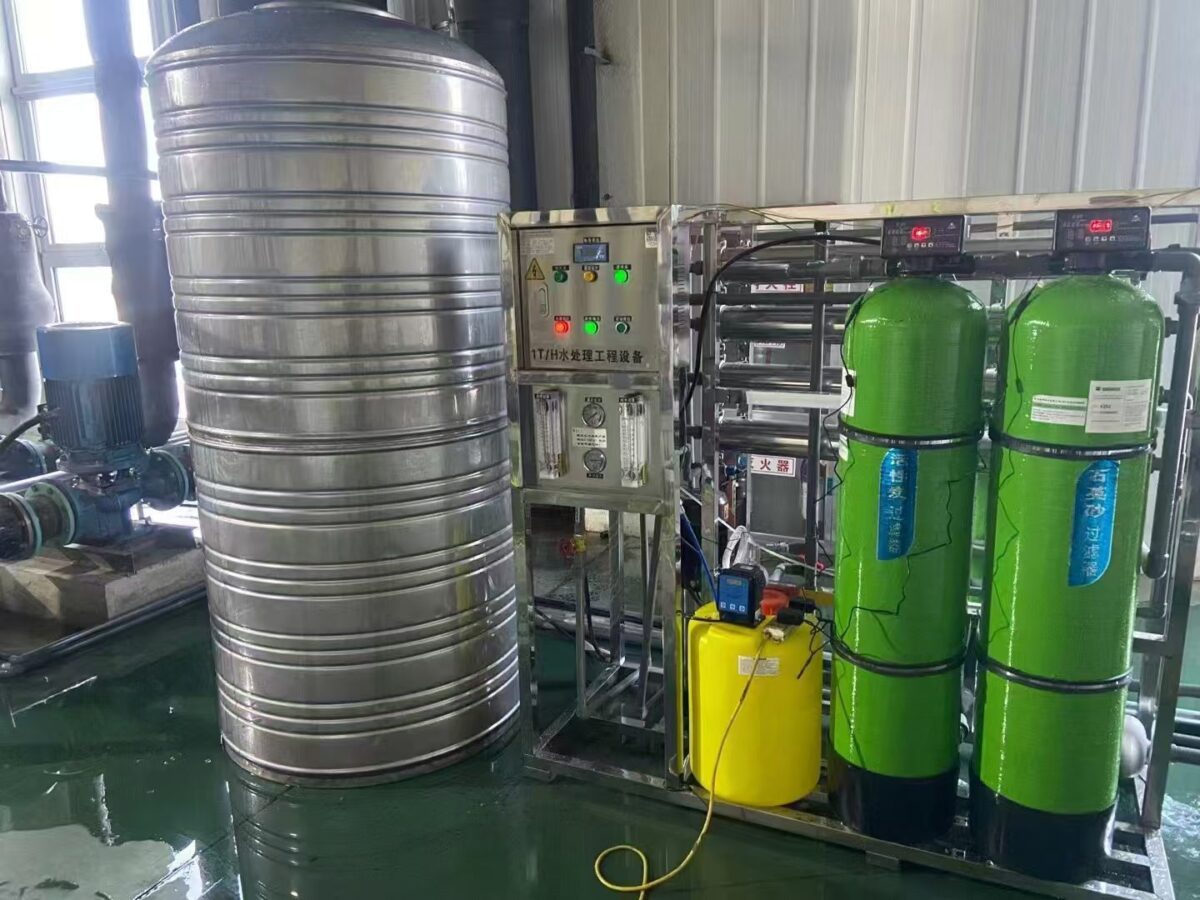 An efficient water treatment system featuring a stainless steel tank, control panel, and green filters.